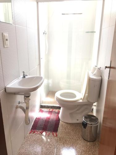 a bathroom with a toilet and a sink at Pousada do Genesio in Petrópolis