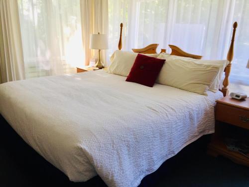 a bed with white sheets and pillows in a bedroom at Sesuit Harbor House in East Dennis