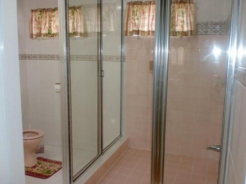 a bathroom with a shower and a toilet at Prime Ocean View Vacation Villa in Plaisance