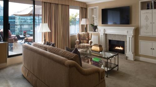 a living room with a couch and a fireplace at Wedgewood Hotel & Spa - Relais & Chateaux in Vancouver
