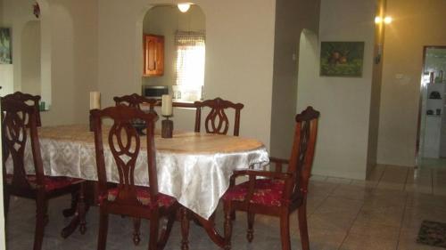 a dining room with a table and four chairs at Prime Ocean View Vacation Villa in Plaisance