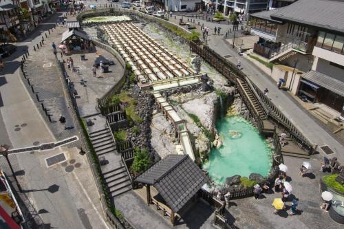 an aerial view of a toy train track and a river at Daitokan in Kusatsu