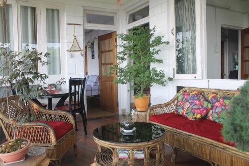 a living room with a couch and a table at Mansarover Home Stay in Kalimpong