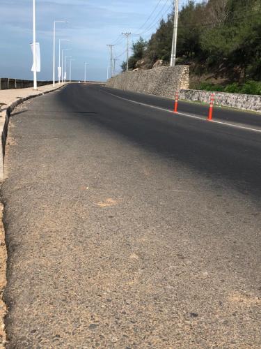 an empty road with orange cones on the side at Quốc Ân Motel in Long Hai