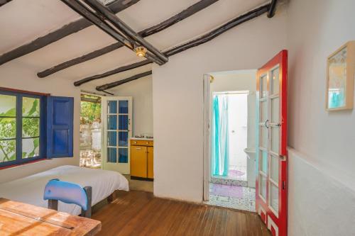 a bedroom with a bed and a table at Botanico Hostel in Bogotá