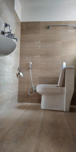 a bathroom with a toilet and a sink and a shower at Sayami Home in Pātan