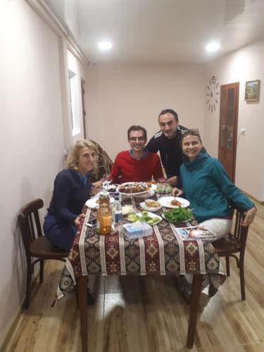 a group of people sitting around a table at Narek B&B in Goris