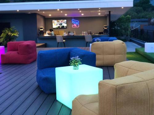 a lobby with couches and chairs and a bar at The Nature Phuket - SHA Extra Plus in Patong Beach