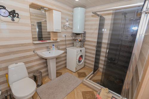 a bathroom with a shower and a toilet and a sink at Black see apartment in K'obulet'i