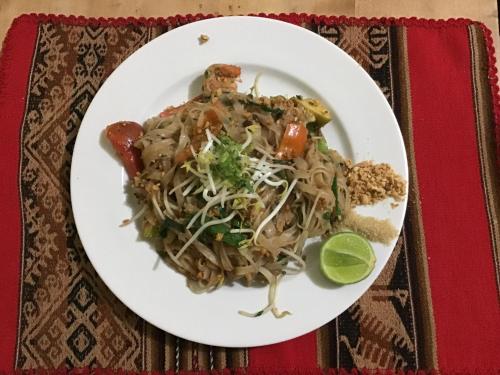 a plate of food with noodles on a table at La Casa de Zarela in Huaraz