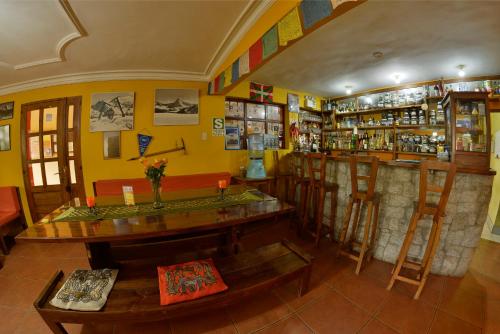 a room with a bar with a table and chairs at La Casa de Zarela in Huaraz