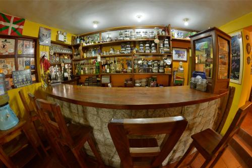 a bar with a wooden counter in a room at La Casa de Zarela in Huaraz