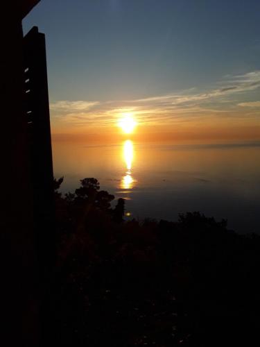 a sunset over the water with the sun in the sky at loft sul mare Sirolo in Sirolo