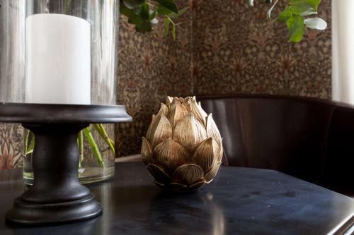 a wooden bowl on top of a table with a candle at Centric Hotel in Norrköping