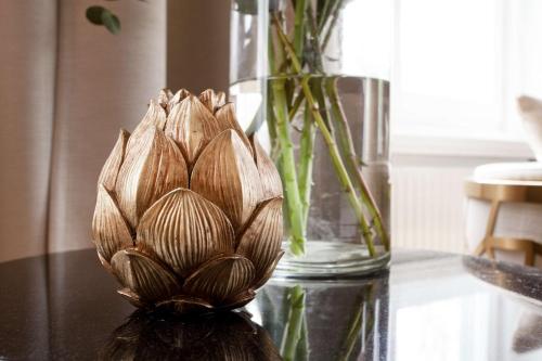 a vase with a plant sitting on a table at Centric Hotel in Norrköping