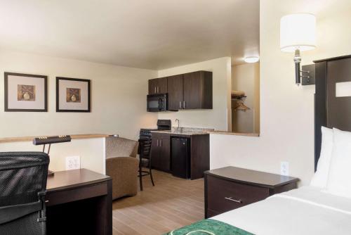 a hotel room with a kitchen and a living room at Baymont by Wyndham Glenwood in Glenwood