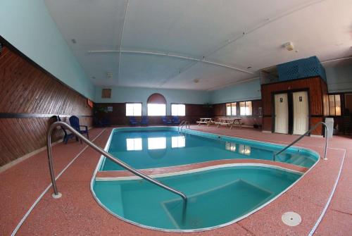 a large swimming pool in a large room at Super 8 by Wyndham Portsmouth in Portsmouth