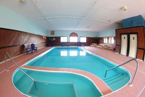 a large swimming pool in a large room at Super 8 by Wyndham Portsmouth in Portsmouth