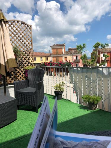 a balcony with a chair and flowers on a fence at Boutique Hotel Palazzo Corso Umberto in Boiano