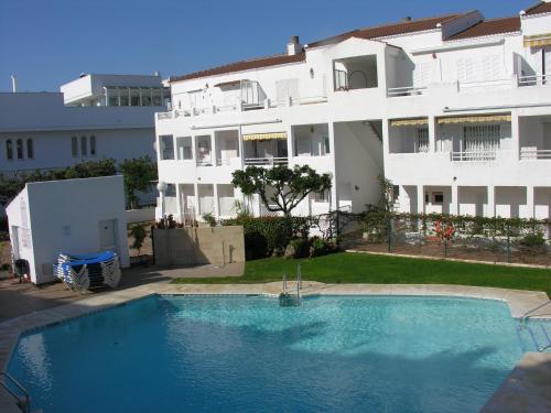 a swimming pool in front of a building at El Piso Del Sol in Fuengirola