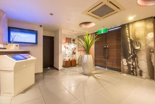 a lobby with a vase with a plant in it at ホテル アン 岐阜-大人専用 in Gifu