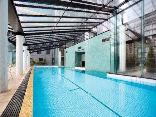 a large swimming pool in a large building at ReadySet Apartments at City Tower in Melbourne