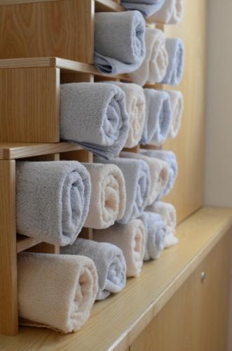 a stack of towels on a shelf in a bathroom at Landhaus Hofer in Neustift im Stubaital