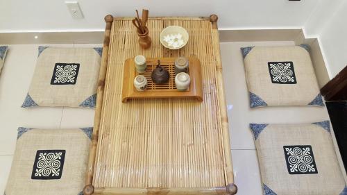 a table with two chairs and a clock on it at Tâm Homestay in Hue
