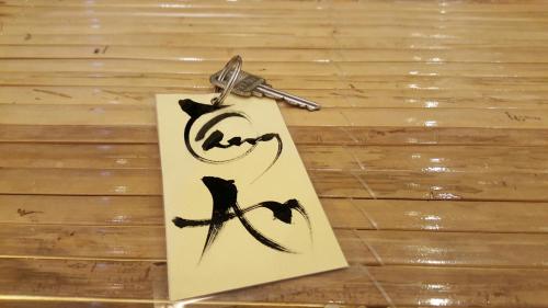 a piece of paper with a key on a table at Tâm Homestay in Hue