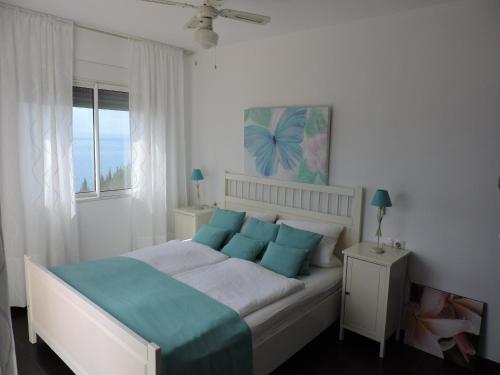 En eller flere senge i et værelse på Villa Romantika