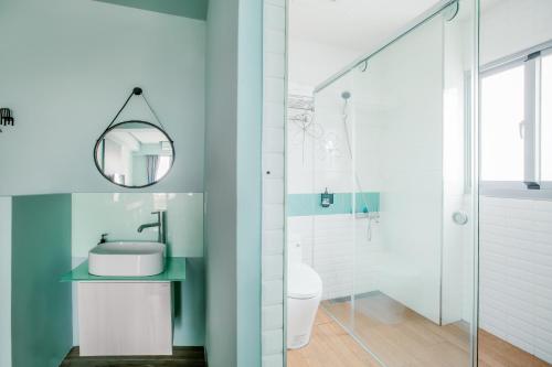 a bathroom with a sink and a shower at Party of the Ocean B&B in Magong