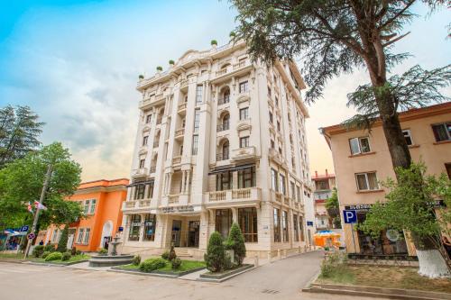 a large white building on a city street at LETO Boutique Hotel Zugdidi in Zugdidi