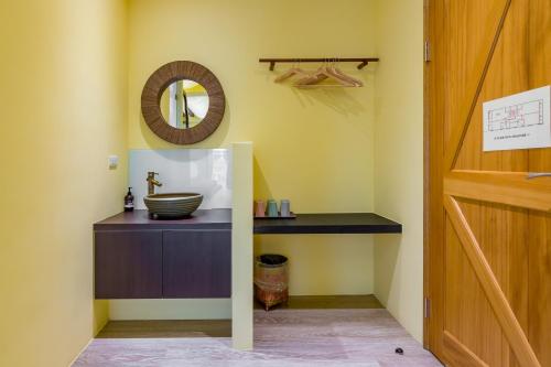 a bathroom with a sink and a mirror on the wall at Party of the Ocean B&B in Magong