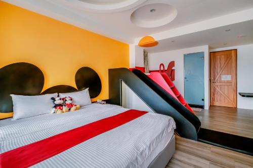 a bedroom with a large bed with two stuffed animals on it at Party of the Ocean B&B in Magong