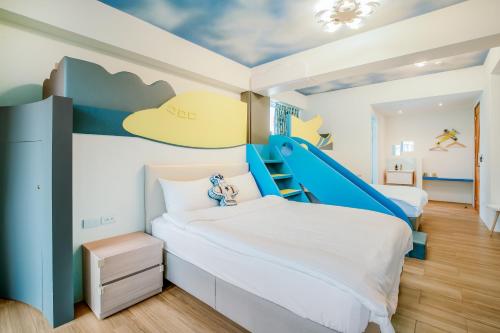 a kids room with two beds and a slide at Party of the Ocean B&B in Magong