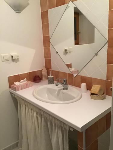 a bathroom with a sink and a mirror at Rêve d’Emma in Plan-dʼOrgon