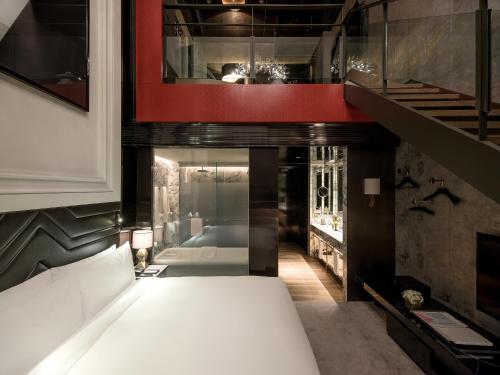 a bedroom with a white bed and a staircase at Art Paradiso, Paradise City in Incheon