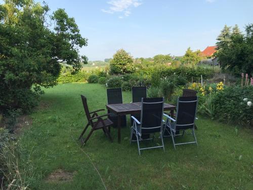 a table and chairs sitting in the grass at 4 Kreuzstraße Laaschhof in Nusbaum