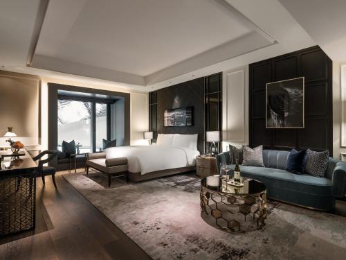 a bedroom with a bed and a couch and a table at Art Paradiso, Paradise City in Incheon