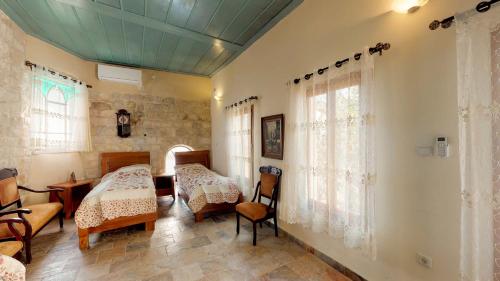 a room with two beds and a table and chairs at HEMDAT NEFESH in Safed