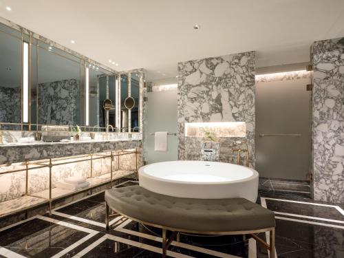 a bathroom with a tub and a large mirror at Art Paradiso, Paradise City in Incheon