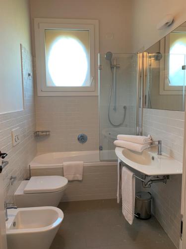 a bathroom with a toilet and a sink and a shower at PALAZZO DE' ROSSI HOTEL in Sasso Marconi
