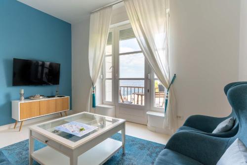 a living room with a glass coffee table and a window at Aquamarine Sea View Apartment in Zadar