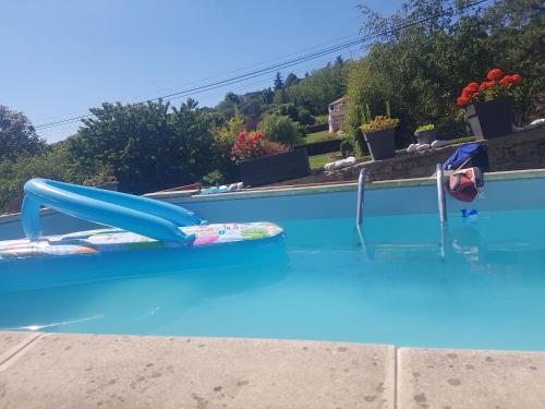 uma piscina com um escorrega de água azul em Le clos Fleury Cluny em Cluny