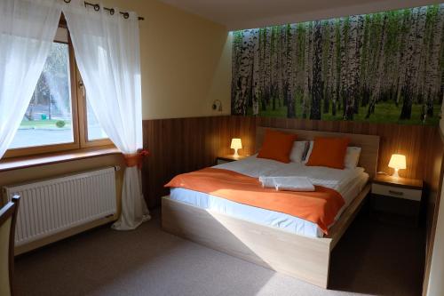 En eller flere senge i et værelse på Leśny Ośrodek Szkoleniowy