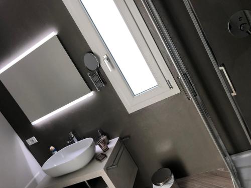 a bathroom with a sink and a mirror at Padua Suite in Padova