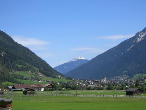 a town in a valley with a snow covered mountain at Landhaus Hofer in Neustift im Stubaital
