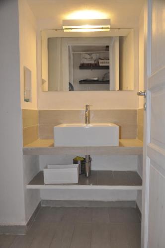 a bathroom with a sink and a mirror at Sole e Mare in Favignana