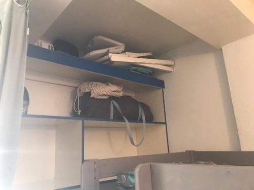 a room with blue shelves with items on it at la Bassure de Baas à Ambleteuse in Ambleteuse