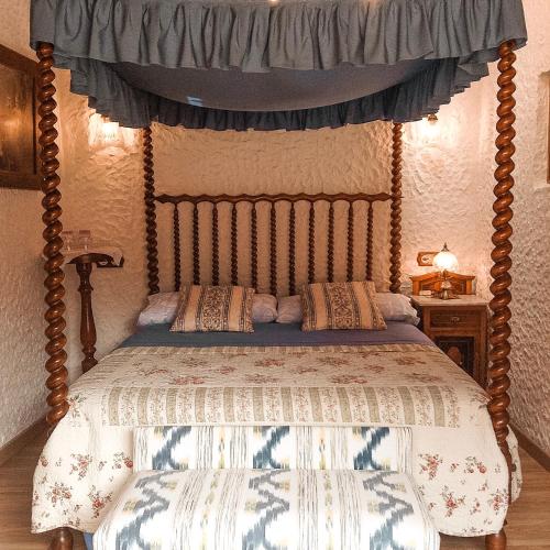 a bedroom with a bed with a canopy at Finca Ses Fontanelles in Andratx
